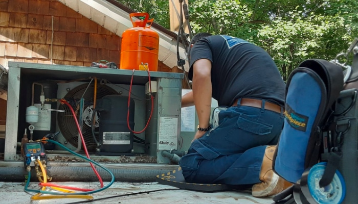 technician checking refrigeration charge